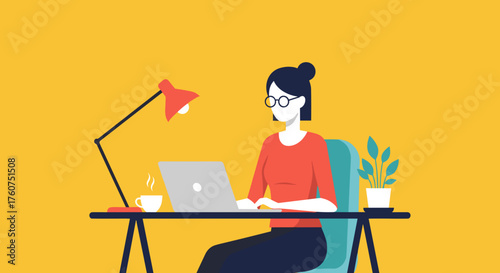 Woman working remotely on laptop at modern home office desk