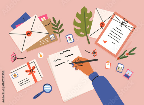Hand writing letter with envelopes and stamps