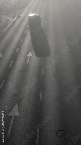 Morning Traffic on Multi-Lane Road in Foggy Weather. 4K video of cars driving away on a wide multi-lane road during a misty morning. Scene of urban traffic with dense fog or smog. Daily commute.