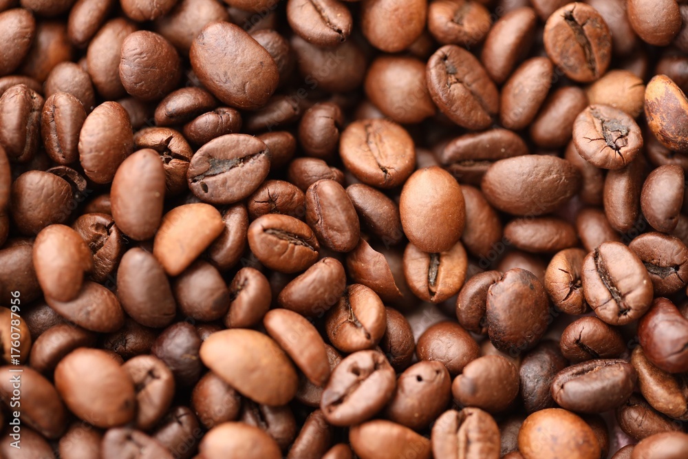 Naklejka premium Big pile of fresh roasted brown coffee beans as flat background photo image with visible details close up