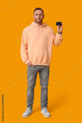 Young man in peach hoodie a...