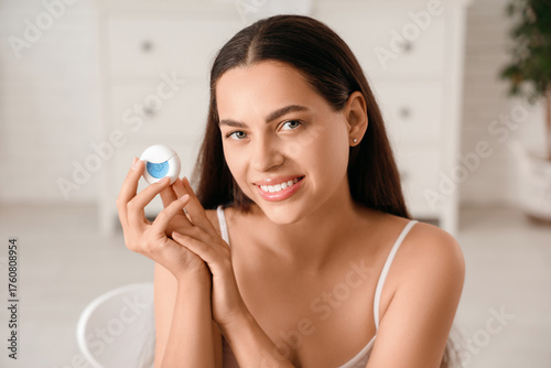 Smiling young woman holding...