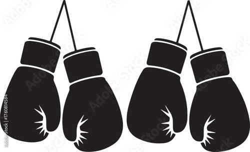 Four black boxing gloves hang suspended ready to fight