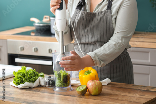 Woman in apron using immers...