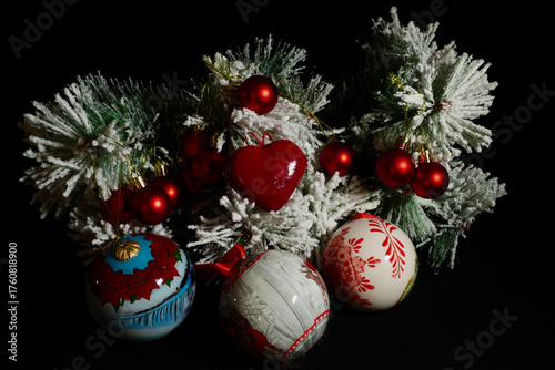 Collection of Christmas decorations arranged on a dark background. Festive ornaments and seasonal elements symbolizing the joyful spirit of the holiday season