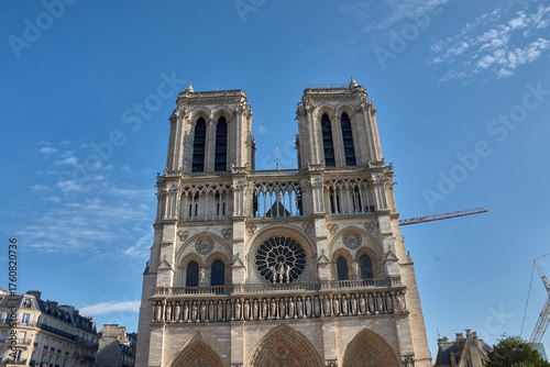 Notre Dame Cathedral in Paris with Gothic architectural details and a restoration crane visible on the facade