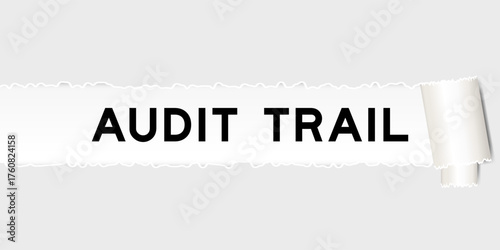 Ripped gray paper background that have word audit trail under torn part