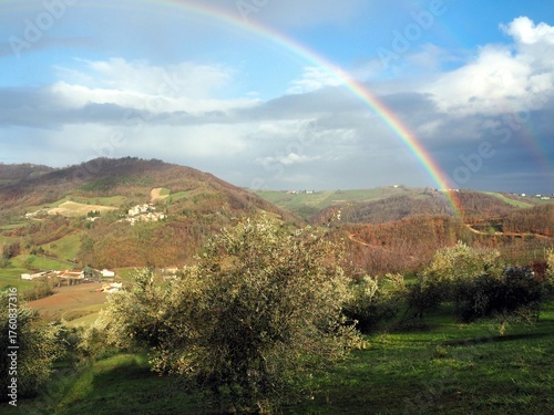 Rainbow over Lush Hills and Olive Groves in Val Termina, Parma, Italy
