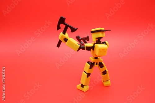 Yellow Action Figure Holding Dual Axes on Red Background