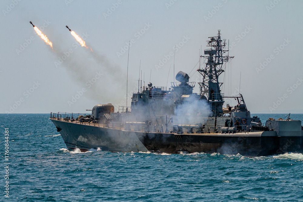 Obraz premium A Navy battleship makes missile launch during fighting with enemy aircraft. War ship shoot with gun. 