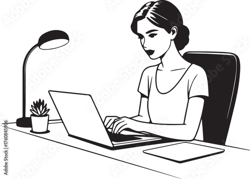 Young woman working diligently on her laptop at a desk