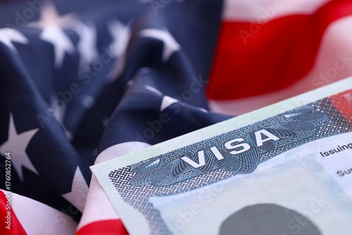 U.S. VISA United States of America. American Tourist or Green Card Visa on flag background close up