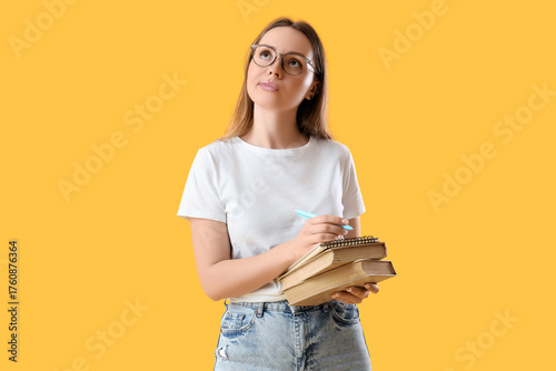 Dreamy young woman writing ...