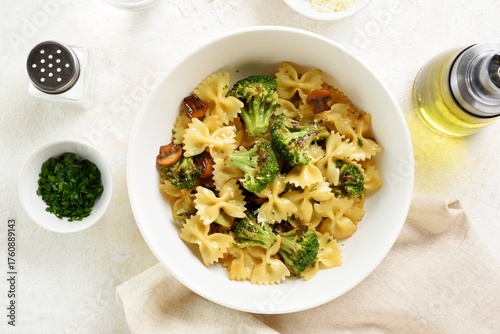 Farfalle pasta with roasted broccoli and mushrooms in bowl
