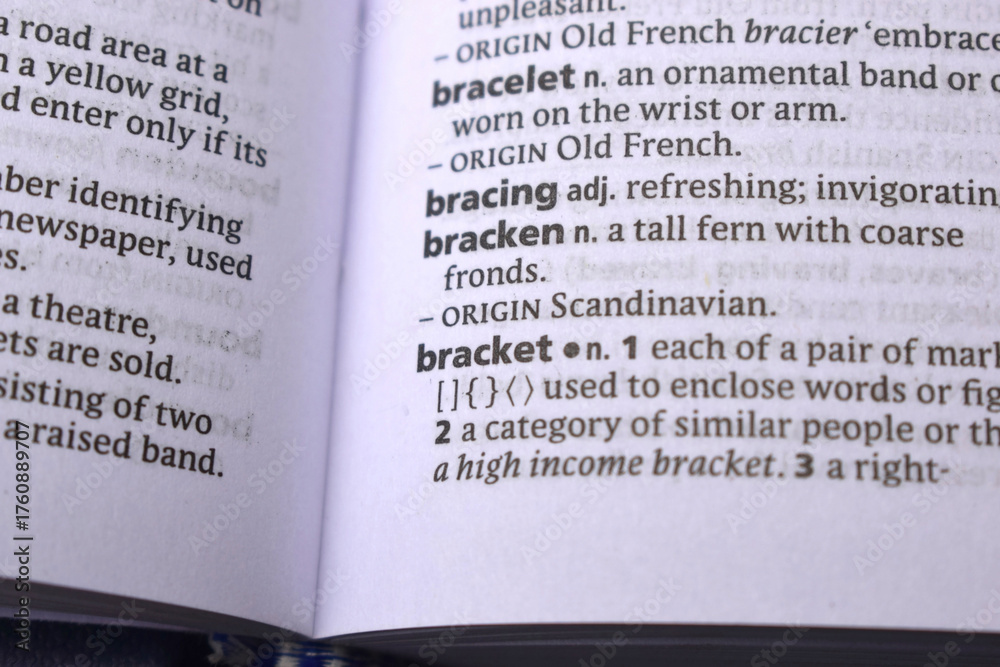 Obraz premium English Definition Dictionary Page Close Up Of Printed Word Of -Bracket