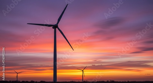 Silhouette of Wind Turbines Against a Dramatic and Colorful Sunset Sky with Vibrant Clouds