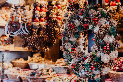 Handmade Pinecone Wreaths With Red Berries On Festive Market Stall