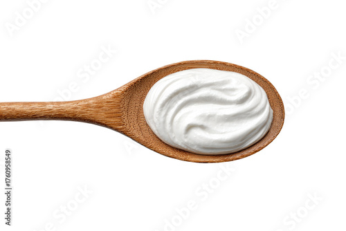 Creamy white sauce in a wooden spoon