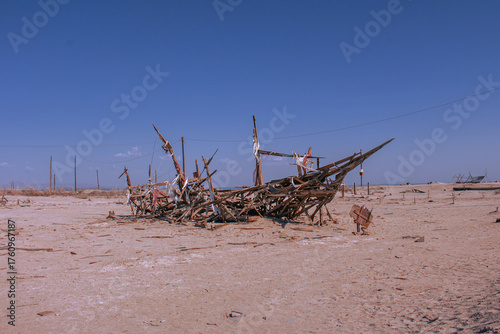 Fotografie Abandoned Ship Wreckage on a Remote Shore – Rusting Boat Decaying by the Sea, Fo