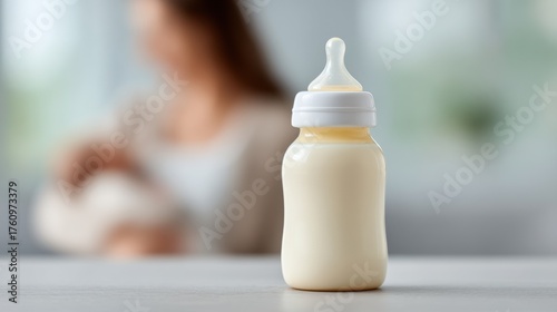 A Close-Up of a Baby Bottle in Focus with a Mother Breastfeeding in a Blurred Background, Capturing a Tender Moment of Nurturing Connection