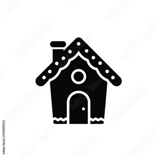 Black silhouette of a gingerbread house with white dots