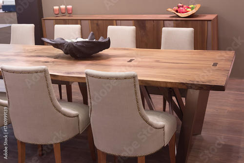 Modern dining room with natural wood table and beige upholstered chairs