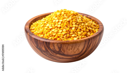 A wooden bowl filled with yellow, split pulses set against a black background