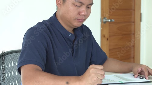 Young asian businessman is suffering pain on wrist, finger and arm, arthritis inflammation while working and he is massaging himself and doing exercise with his hands to relax and to relieve pain.	
