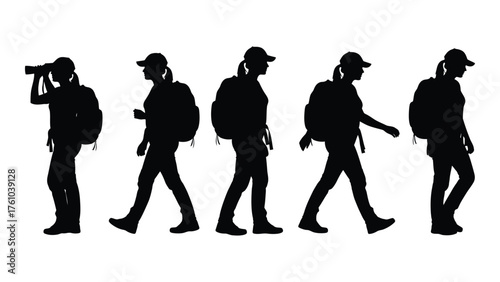 Silhouetted hikers walking and photographing outdoors in a row silhouette