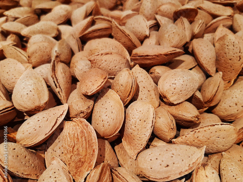 Organic fresh almonds at the market. Background of natural nuts. Healthy eating. Heap of almonds close up. Shelled almonds, full frame