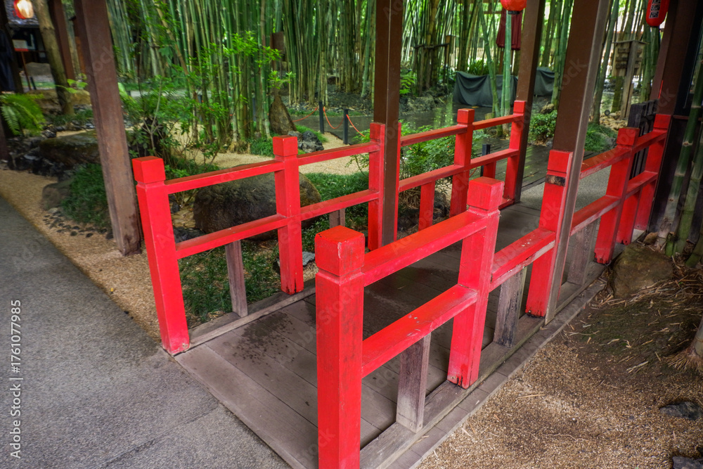 Fototapeta premium Japanese red wooden bridge with stones and pond,Japan traditional architecture for garden,Japanese,architecture,cultural aesthetics.