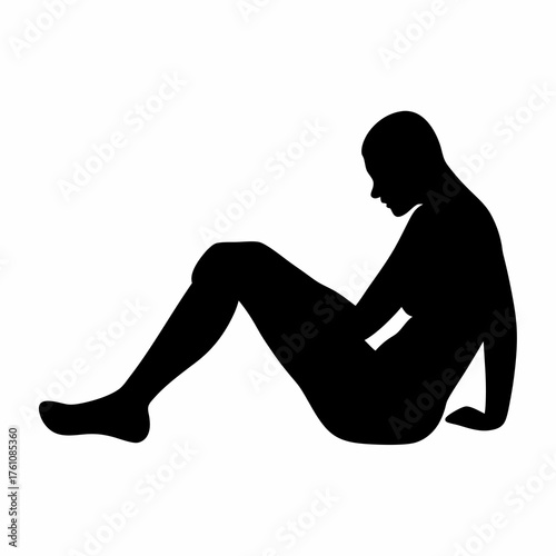 Silhouette of a person sitting with head bowed in a reflective pose