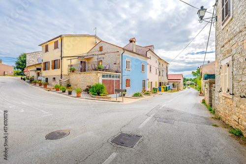 Fototapeta Naklejka Na Ścianę i Meble -  Colorful historic buildings line the streets of the medieval hill town of Sveti Lovreč, Croatia, a small rural village in the mountains of Istria.