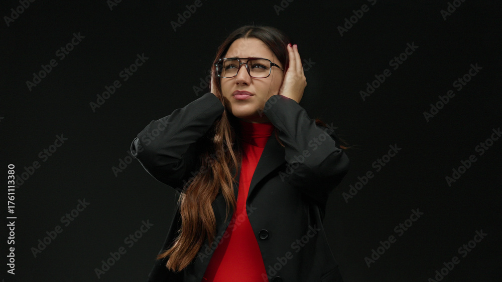Obraz premium Young woman in glasses feeling stressed over isolated black background, dressed in formal attire displaying frustration and anxiety in an expressive manner.