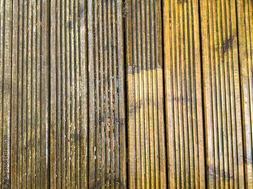 Before and after view of dirt and grime being cleaned from wooden decking using a pressure washer. DIY concept.