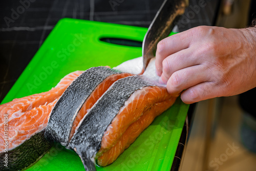 Photography Cutting salmon fillet into steaks