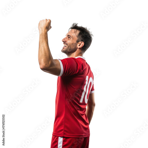 Soccer player in red jersey celebrating a victory with fist pump