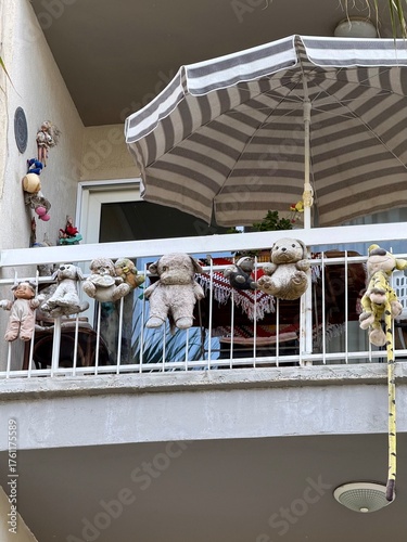 Tableau sur toile Balcony covered with old, faded stuffed toys
