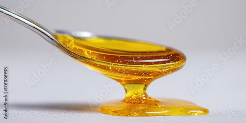 THC distillate concept with honey-like cannabis concentrate on spoon