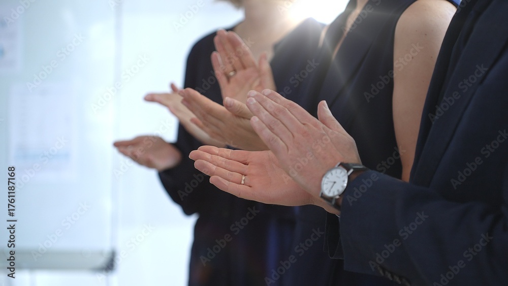 Obraz premium Group of business people clapping hands celebrating achievement, showing appreciation and support during a corporate meeting or seminar at a bright office conference