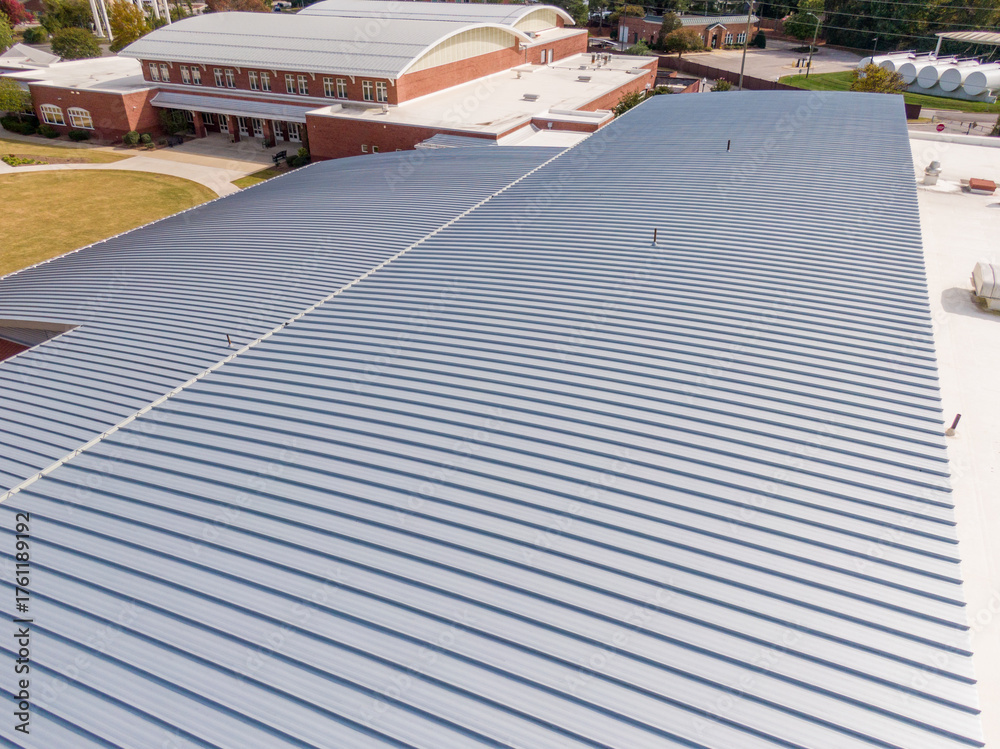Fototapeta premium Sunny Daytime Drone Images of a New Commercial Building With A Large Standing Seam Metal Roofing System