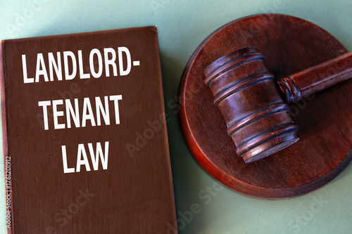 Brown book with the text LANDLORD-TENANT LAW with a judge's gavel