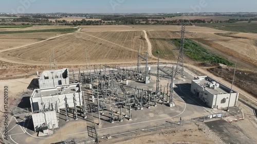 Electric power station and urban energy hub supplying electricity to the city. Industrial infrastructure and energy network under bright daylight.