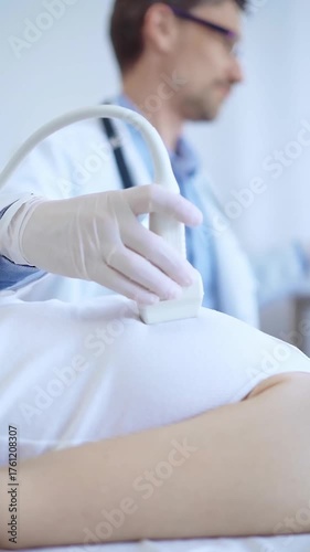 Doctor man is using ultrasound machine to examine internal organs of a patient woman. Female mammary gland health, cancer prevention. Medicine
