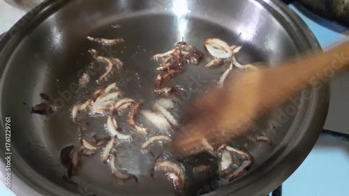 Onion fried in oil for seasoning ingredient recipe video footage. 