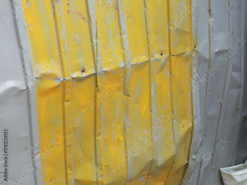 a broken profiled fence painted yellow. cabin.