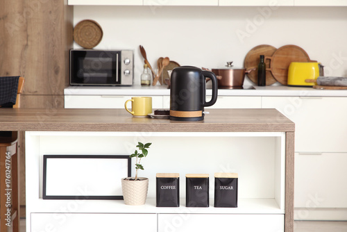 Black electric kettle on ta...