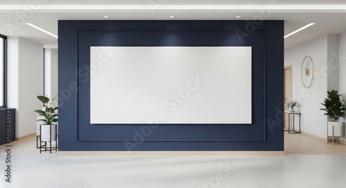 Modern office interior with a large blank white display screen on a dark blue wall.
