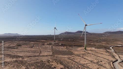 tow wind turbine working in the desert - Canary islands - aerial view drone 4k