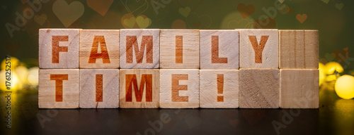 Photos FAMILY TIME! spelled out on wooden blocks, symbolizing togetherness, love, and cherished moments with loved ones